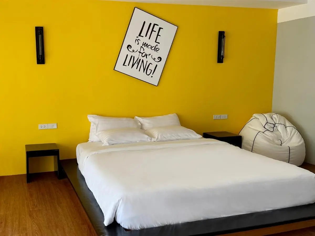 Bright Superior room with the signature warm-yellow feature wall